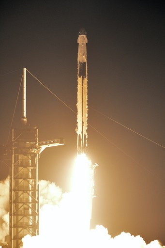 Falcon Heavy launching with Crew Dragon during the night, from a public domain SpaceX photo